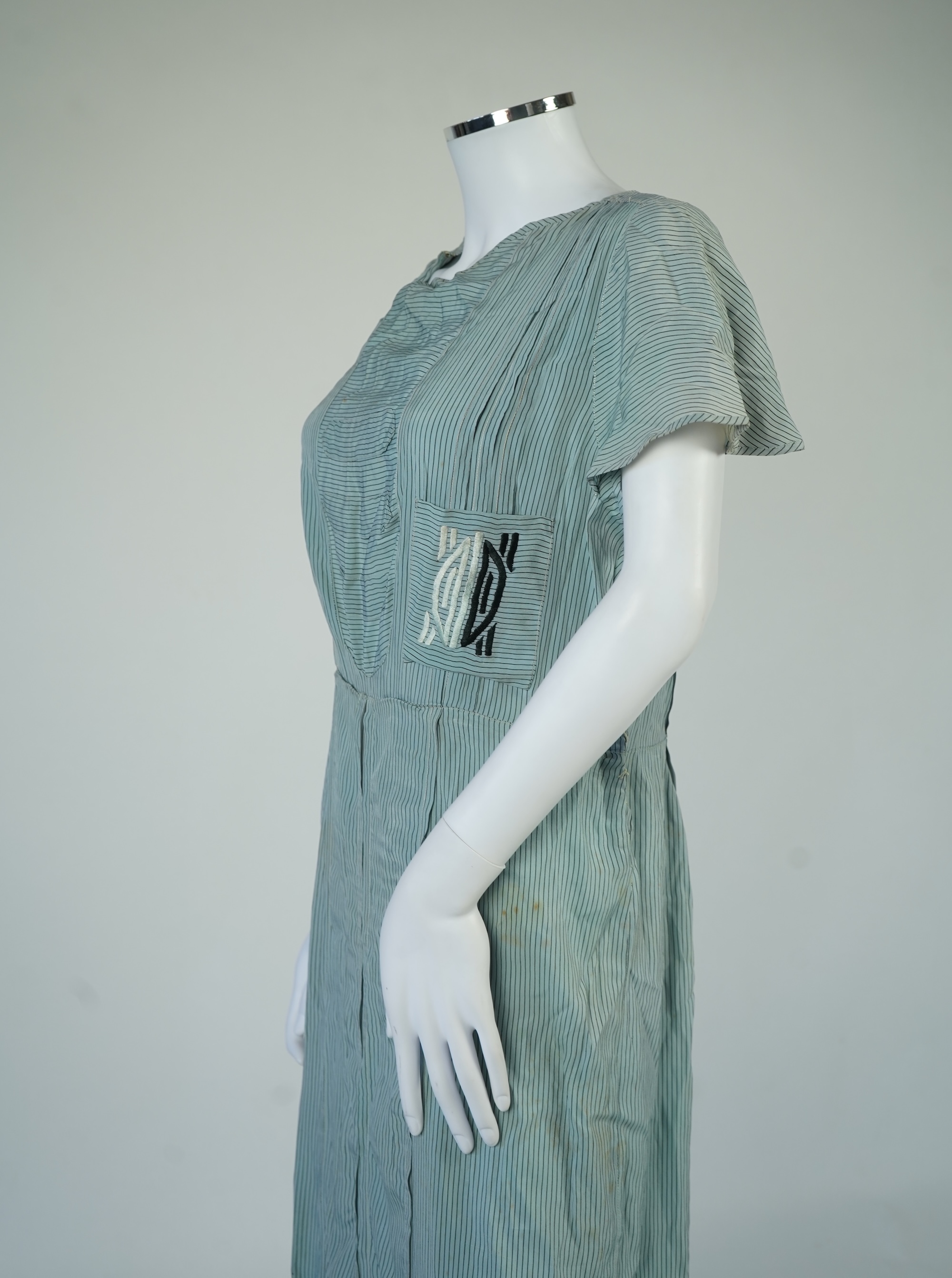 Two 1930's printed silk crepe summer day dresses together with a similar pale blue and black stripped summer day dress., Condition - the maroon and cream dress has damage to one sleeve, the green dress has worn under the